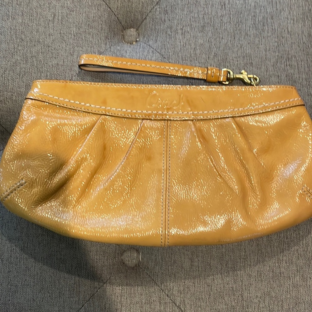 Beautiful new with tags, coach wristlet purse. In a brown leather finish.